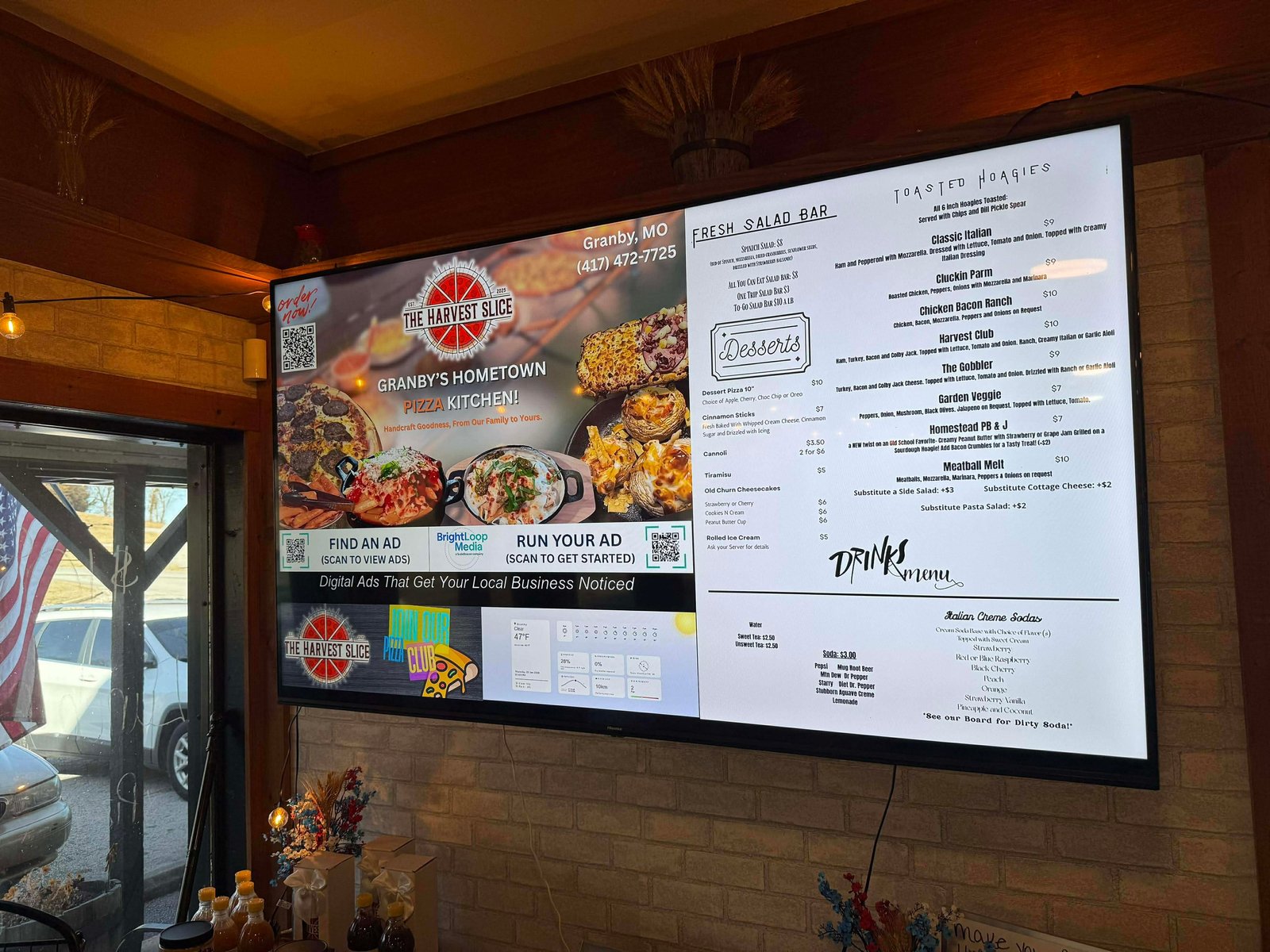 BrightLoop Media digital screen inside a local pizza restaurant
